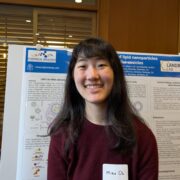 Mina Oh standing in front of a scientific poster