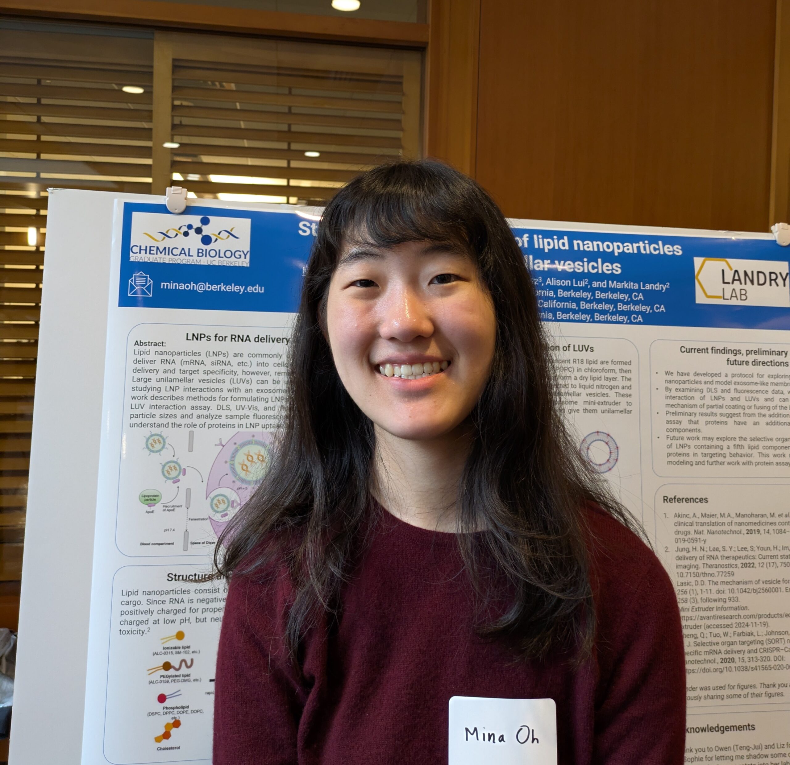 Mina Oh standing in front of a scientific poster
